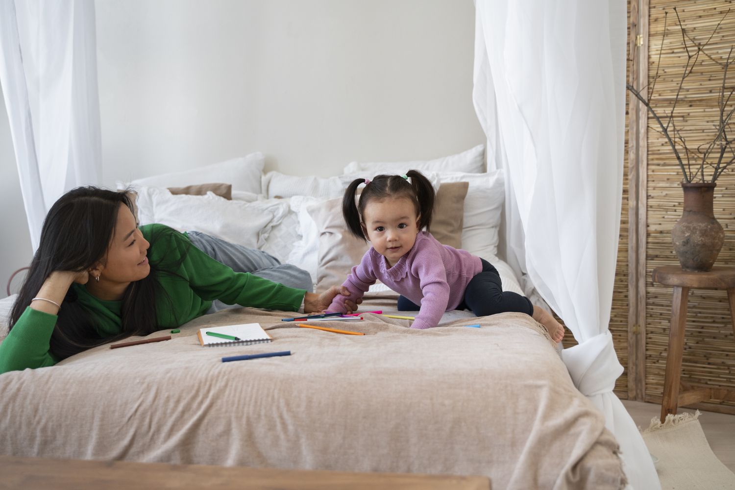 A domestic helper caring for a newborn baby