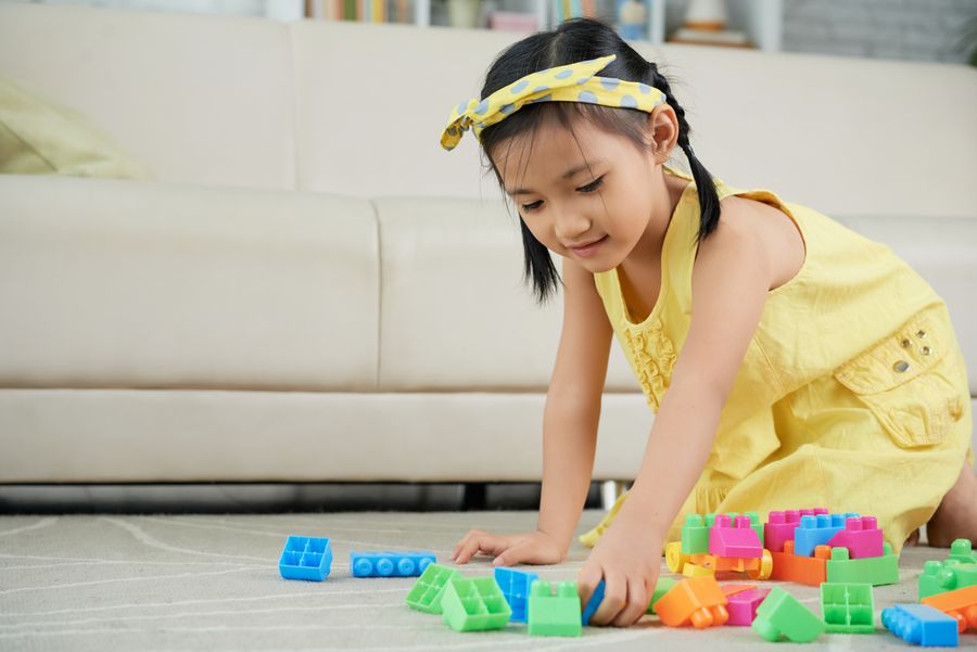 A domestic helper caring for a young child at home in Hong Kong
