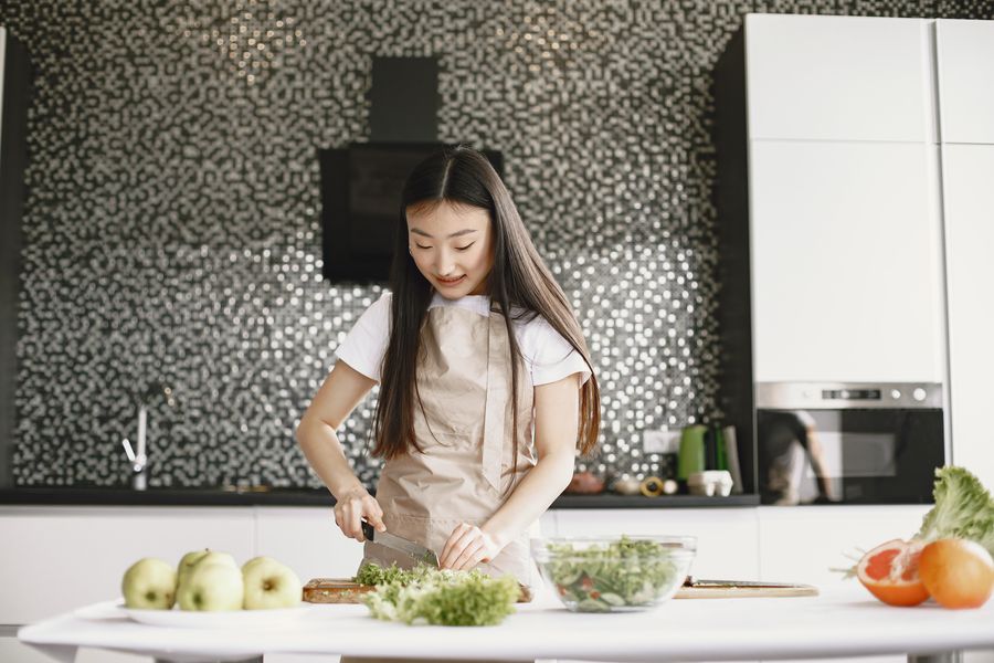 A domestic helper cooking a family meal